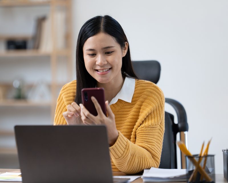 woman employee on phone and laptop in office