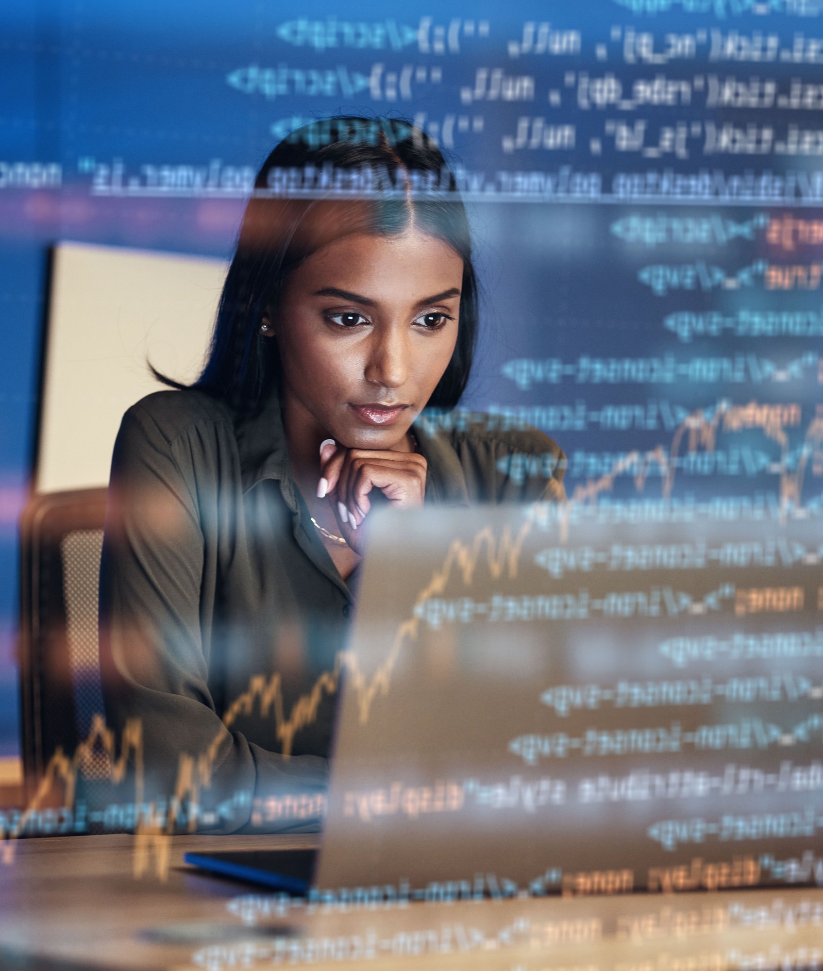 woman looks at data on a computer screen with numbers and projects overlaid