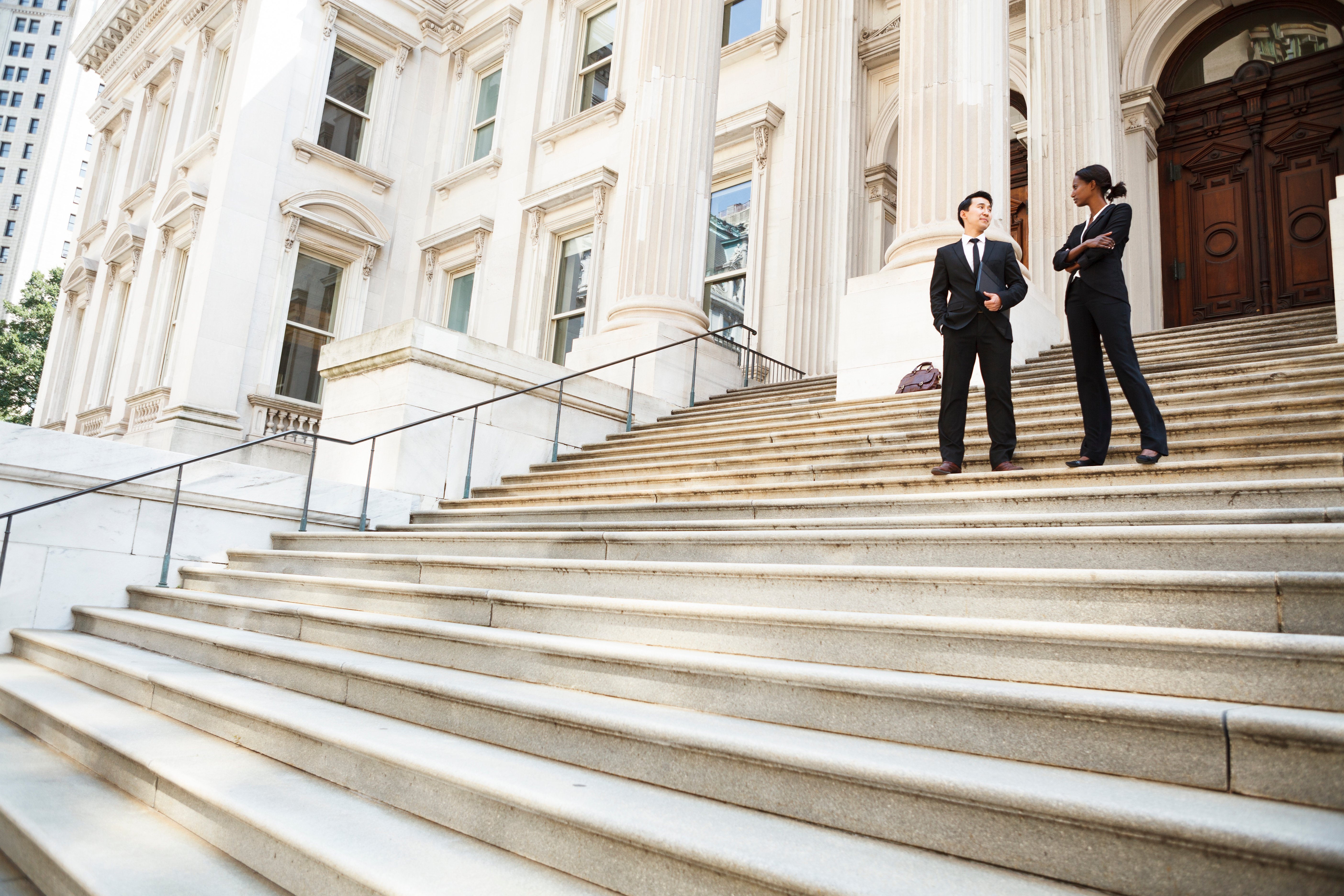  Government IT solutions personale in front of stately building. 