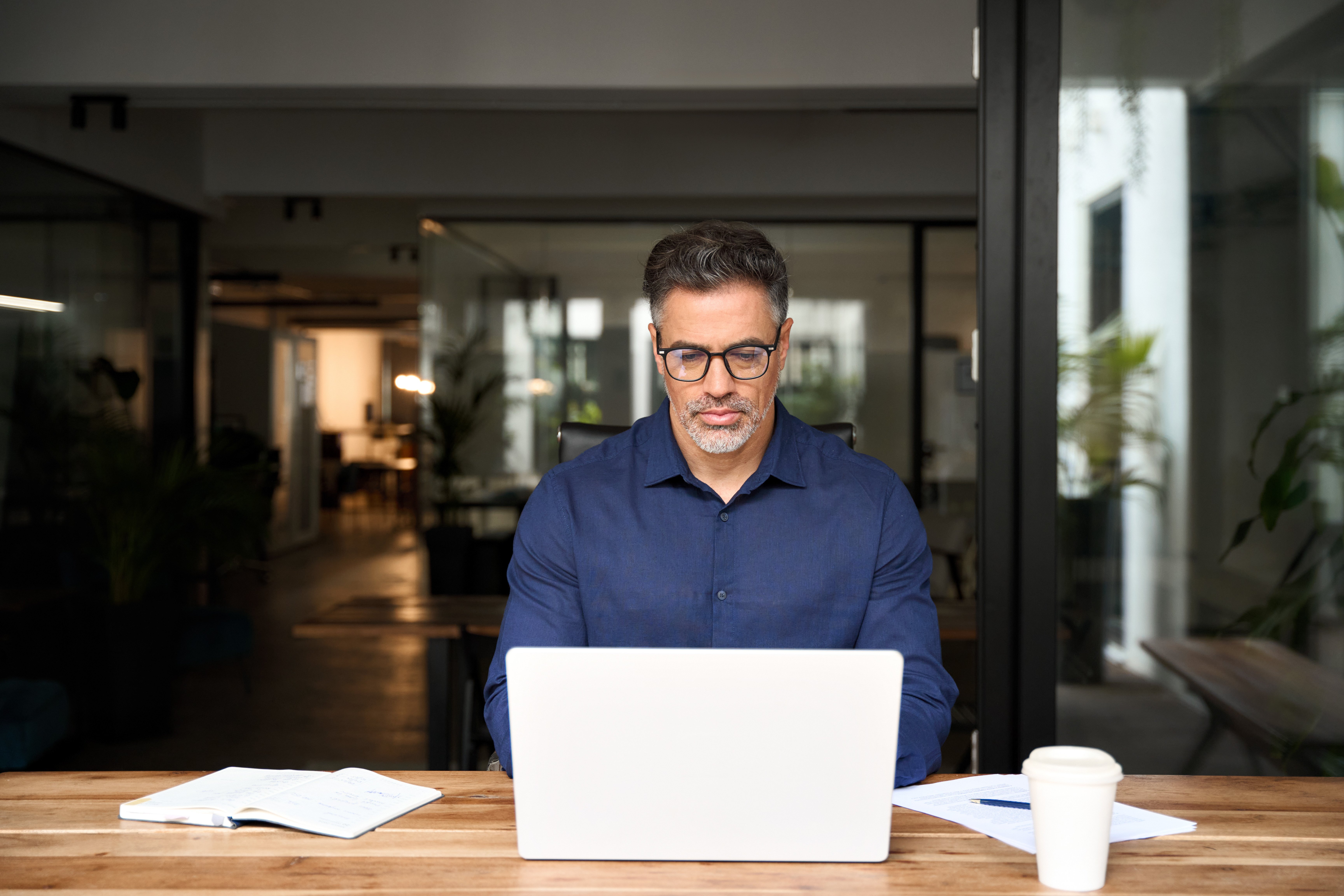 business man typing on laptop in office 