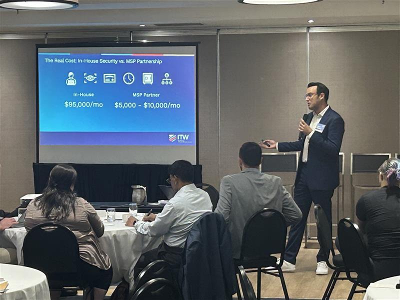 IT Weapons presenter discussing managed IT services with business leaders at a Greater Toronto event
