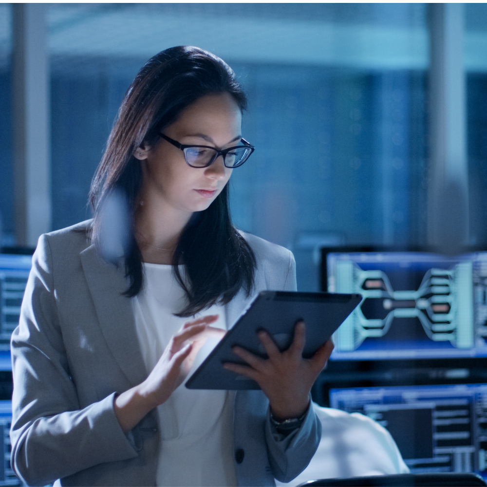business woman in server room on tablet