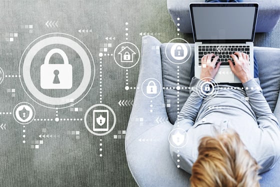 person using a secure laptop while sitting in chair
