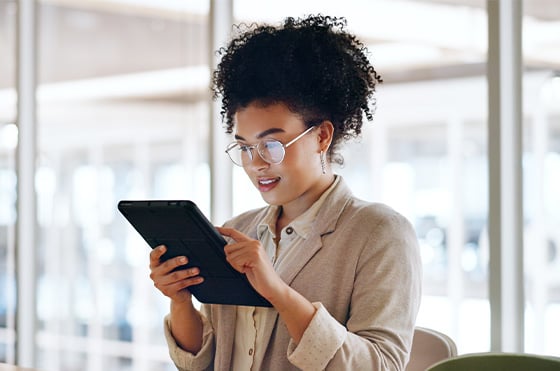 woman tapping items on a tablet device