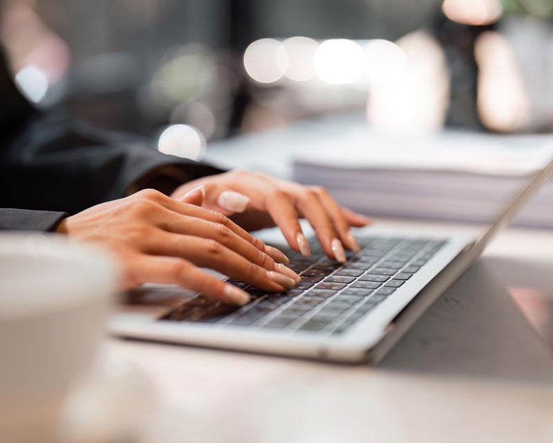 A person typing on a laptop.