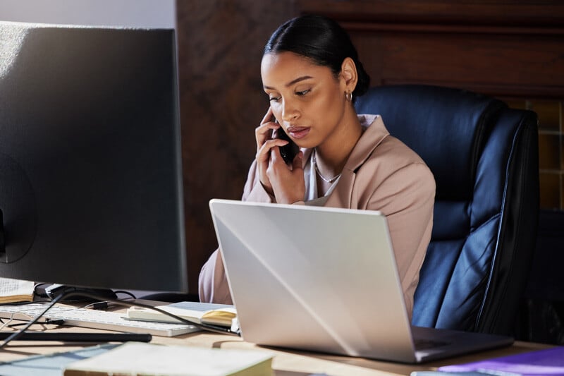 A professional working in office at a computer.