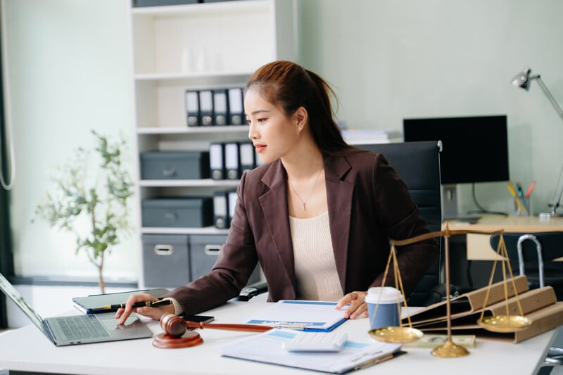 A lawyer in her office working on a laptop.
