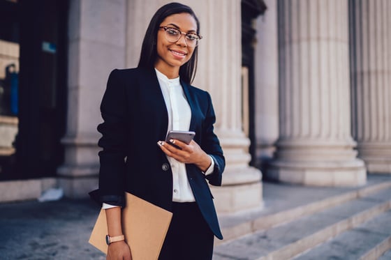 A lawyer standing outside of a courthouse, relying on IT security services to protect sensitive client information.