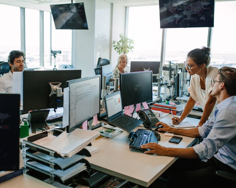 People working on computers in an office.