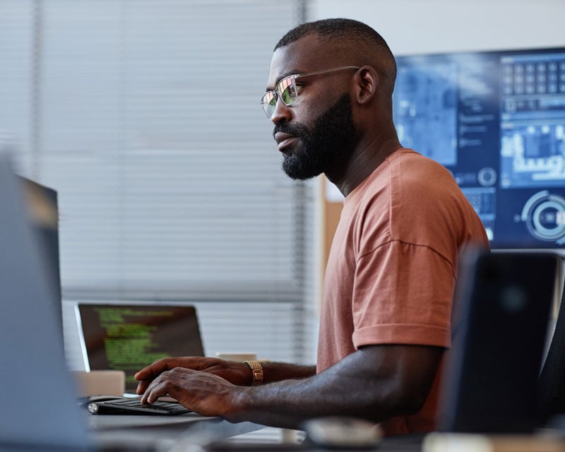person typing on desktop device in an office